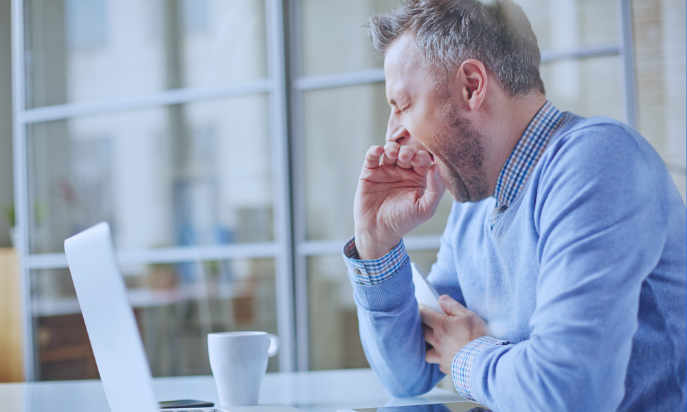 Image of a young girl receiving a medical examination from a nurse using a digital thermometer, while her mother closely watches. The nurse, in blue scrubs, is attentively engaging with the child, who appears calm. The mother, standing beside her daughter, looks on with concern. The setting is a medical office, illuminated in a serene blue tone to create a calm and professional atmosphere.