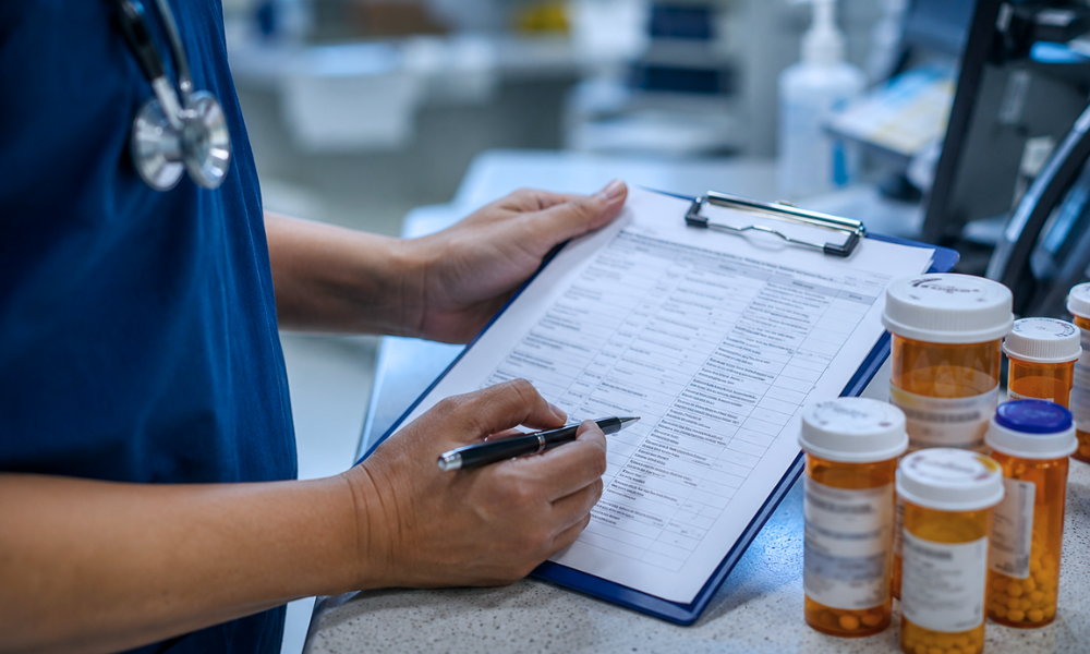 Image of a young girl receiving a medical examination from a nurse using a digital thermometer, while her mother closely watches. The nurse, in blue scrubs, is attentively engaging with the child, who appears calm. The mother, standing beside her daughter, looks on with concern. The setting is a medical office, illuminated in a serene blue tone to create a calm and professional atmosphere.